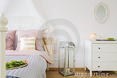 Bed, dresser and decorative lantern Stock Photo