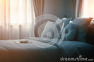 Bed maid-up with clean white pillows and bed sheets in beauty room. Close-up. Lens flair in sunlight. Stock Photo