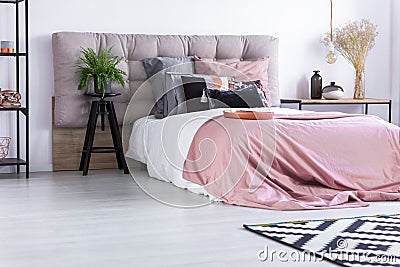 Bed with pink quilt cover Stock Photo