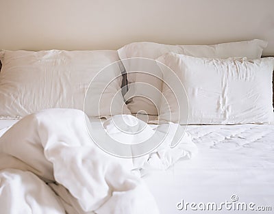 Bed sheet mattress and pillows messed up Stock Photo