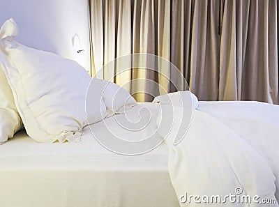 Bed sheet and pillow messed up in bedroom Stock Photo