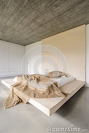 Bed on wooden platform Stock Photo