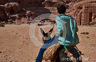 Bedouin child ride your donkey Petra Editorial Stock Photo