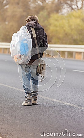 Bedouin walking on the road Stock Photo