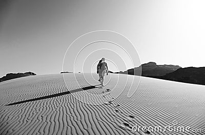 Bedouin Walking on the Sand Dunes in Wadi Rum Desert, Jordan in Black and White Editorial Stock Photo