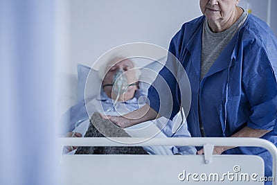 Bedridden man wearing oxygen mask Stock Photo