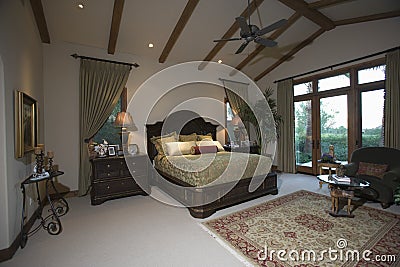 Bedroom With Beamed Ceiling And Patio Doors Stock Photo