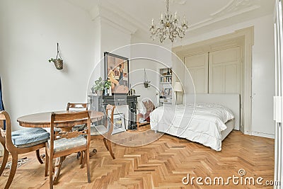 a bedroom with a bed and a table and chairs Editorial Stock Photo