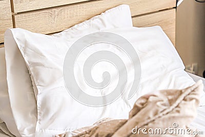 Bedroom, brown wooden bed, with two white pillows, after wake in morning Stock Photo