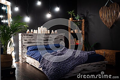 The bedroom is a dark room, with a mirror framed by light bulbs Stock Photo