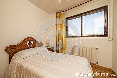 Bedroom with double bed with tacky wooden headboard in a room Stock Photo