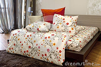 Bedroom with floral bedlinen Stock Photo