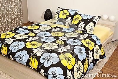 Bedroom with floral bedlinen Stock Photo