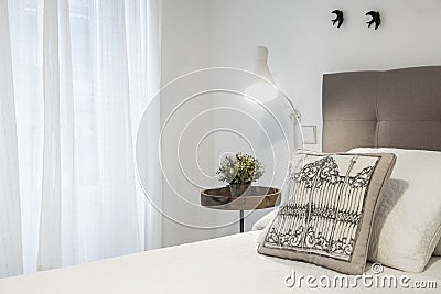 bedroom headboard detail with cushions, lamp and decorative pieces Stock Photo