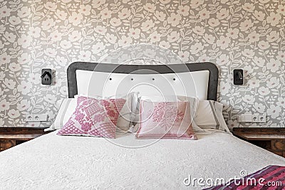 Bedroom headboard upholstered in gray and white satin fabric, Stock Photo