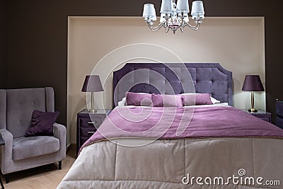 Bedroom interior. The bedroom is decorated in purple shades. Fashionable color 2022 very peri Stock Photo