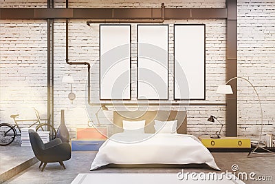 Bedroom interior with white walls and three narrow vertical posters on them. Stock Photo