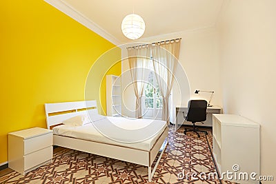 Bedroom with large bed and desk in renovated apartment Stock Photo