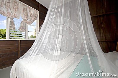 Bedroom mosquito net guest house bequia Stock Photo