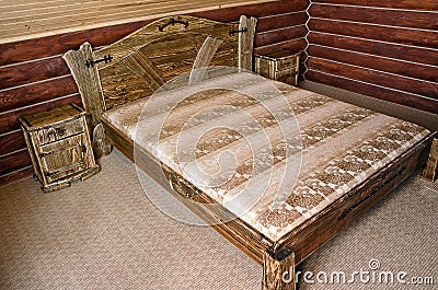 Bedroom with old-style wooden bed Stock Photo