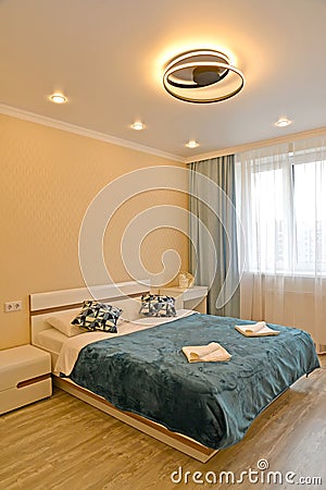 Bedroom with an original lamp in a modern style Stock Photo