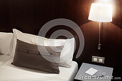 Bedroom, pillow and lamp at night Stock Photo