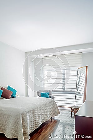 bedroom, room, in the background you can see a bathroom, with mirrored sliding door, wooden door Stock Photo