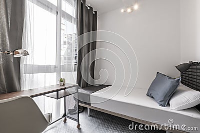 Bedroom with single bed, industrial style study table with resin Stock Photo