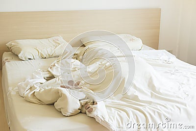 Bedroom with undone bed Stock Photo