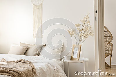 Bedside table with mug and framed picture, real photo Stock Photo