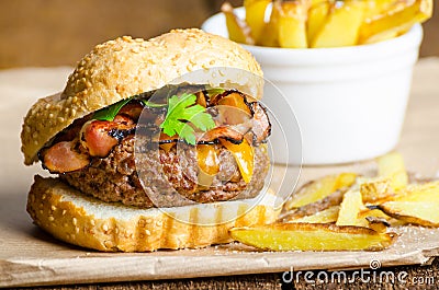 Beef burger with bacon, cheddar, homemade fries Stock Photo