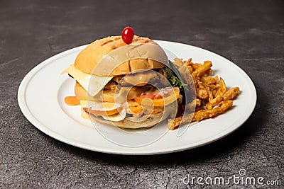 Beef Burger with cheese, mayo and french fries served in dish isolated on background top view of bangladesh food Stock Photo