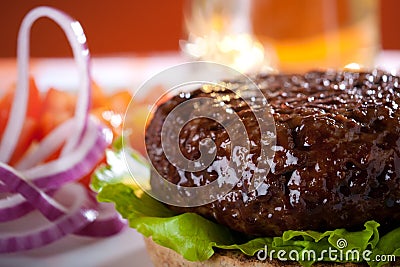 Beef burger with onion and beer on background Stock Photo