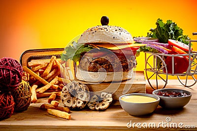 Beef Cheese burger with french fries, potato and tomato slice isolated on wooden board slide view on table fast food Stock Photo