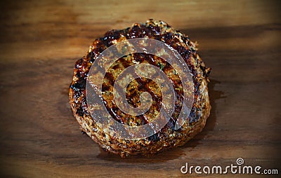 Beef hamburger beef meat patty, barbecued with grill marks Stock Photo