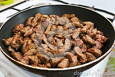 Beef liver bits on a pan Stock Photo