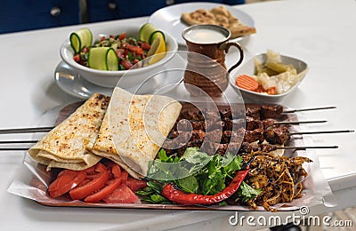 Beef liver kebab with vegetables and ayran Stock Photo