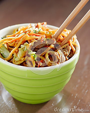 Beef lo mein in a bowl with chopsticks Stock Photo