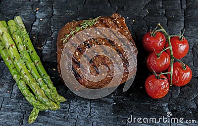 Beef steak grilled with asparagus tomatoes spice Stock Photo
