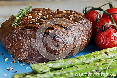 Beef steak grilled with asparagus, tomatoes, spice Stock Photo