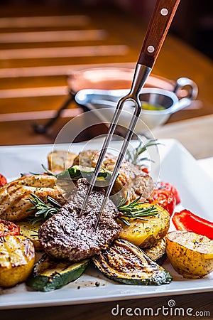 Beef Steak. Sirloin steak. Delicious juicy beef steak on fork. grill vegetables Stock Photo