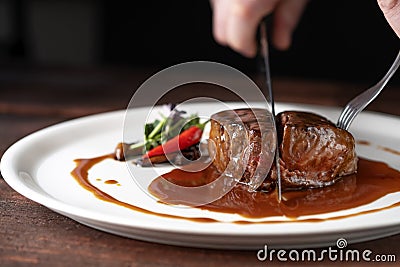 Beef tenderloin steak in demiglas sauce is cut Stock Photo