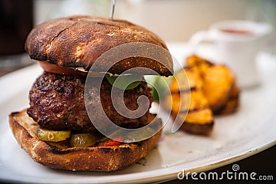 Beefburger with fried potatoes Stock Photo