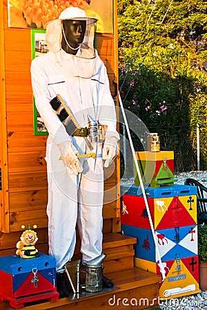 Beekeeper model with equipment and protective clothing Stock Photo