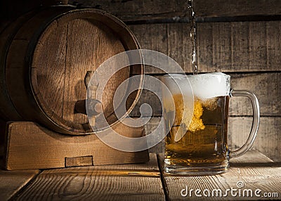 Beer barrel with beer mug on wooden background Stock Photo