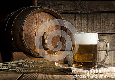Beer barrel with beer mug on wooden background Stock Photo
