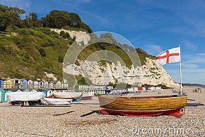 Beer beach Devon England UK with boats and English flag the cross of St George on the Jurassic Coast Stock Photo