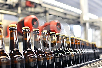 Beer bottles on the assembly line in a modern brewery - industrial plant in the food industry Stock Photo