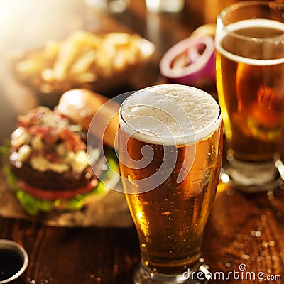 Beer and burgers on wooden table Stock Photo