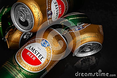 Beer cans. Wet crumpled empty beer cans with water drops on a dark background, top view. AMSTEL is a world famous brand from the Editorial Stock Photo